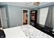 Cozy bedroom featuring a decorative grey quilt, built-in bookshelf, and ensuite bathroom access at 10622 Young Lake Dr, Indianapolis, IN 46239