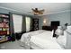 Spacious primary bedroom boasting a ceiling fan, built-in bookshelves, and ample natural light at 10622 Young Lake Dr, Indianapolis, IN 46239