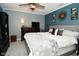 Comfortable main bedroom featuring neutral-toned walls, soft carpet, a ceiling fan, and large decorative sunburst at 10622 Young Lake Dr, Indianapolis, IN 46239