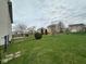 Large fenced backyard with mature trees and landscaping at 1071 Hazelwood Dr, Greenwood, IN 46143
