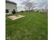 Spacious backyard with grass and fence plus a fire pit area by the house at 1071 Hazelwood Dr, Greenwood, IN 46143