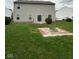Large backyard with a fire pit area and sliding glass doors leading into the home at 1071 Hazelwood Dr, Greenwood, IN 46143