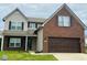 Charming two-story home with brick and vinyl siding, attached garage, and well-maintained lawn at 1071 Hazelwood Dr, Greenwood, IN 46143