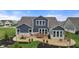 Inviting backyard featuring a spacious patio, landscaped garden beds, and a well-maintained lawn at 11450 Wicker Ln, Noblesville, IN 46060