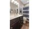 Elegant bathroom showcasing a modern vanity with dark cabinets, complemented by stylish fixtures and finishes at 11450 Wicker Ln, Noblesville, IN 46060