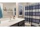 Stylish bathroom featuring a sleek vanity, a large mirror, and a charming bicycle wall decoration at 11450 Wicker Ln, Noblesville, IN 46060