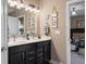 Chic bathroom features a double vanity with modern fixtures, complemented by stylish decor and ample lighting at 11450 Wicker Ln, Noblesville, IN 46060