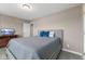 Comfortable bedroom featuring neutral tones, a bed with blue pillows and a modern dresser at 11450 Wicker Ln, Noblesville, IN 46060