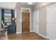 Inviting entryway with stylish flooring, a wood door, and a functional desk and chair setup at 11450 Wicker Ln, Noblesville, IN 46060