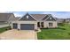 Charming home featuring a two-car garage, a well-manicured lawn, and neutral brick exterior at 11450 Wicker Ln, Noblesville, IN 46060