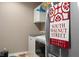 Convenient laundry area with modern appliances and overhead storage, perfect for efficient chores at 11450 Wicker Ln, Noblesville, IN 46060