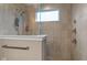 Modern shower stall with luxurious tile work, multiple shower heads, and a built-in window at 11450 Wicker Ln, Noblesville, IN 46060