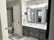 Bright bathroom featuring double vanity sinks, modern fixtures, and a large mirror reflecting a bedroom view at 1198 Paradise N Way # C, Greenwood, IN 46143