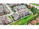 Scenic aerial view of townhomes with maintained lawns, trees, and proximity to roadways at 12658 Watford Way, Fishers, IN 46037