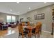Elegant dining area featuring a wooden table, comfortable chairs, hardwood floors, and ample natural light at 12658 Watford Way, Fishers, IN 46037