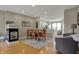 Charming dining area with a modern fireplace, adjacent to an open kitchen and a comfortable living space at 12658 Watford Way, Fishers, IN 46037
