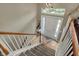 Open foyer showcasing a bright white front door, hardwood floors, and a view from the staircase at 12658 Watford Way, Fishers, IN 46037