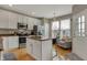 Spacious eat-in kitchen featuring stainless steel appliances and an island with seating at 12658 Watford Way, Fishers, IN 46037