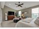 Serene main bedroom features a large bed, comfortable seating, and vaulted ceilings at 12658 Watford Way, Fishers, IN 46037