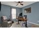 A tidy home office with a modern desk, an adjustable chair, and a comfy recliner at 12658 Watford Way, Fishers, IN 46037