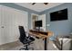 Well-appointed home office features an adjustable desk, a comfortable chair, and sleek technology at 12658 Watford Way, Fishers, IN 46037