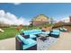 Outdoor patio with comfortable wicker seating, an area rug, and lovely views of the manicured lawn at 13974 Nina Dr, Carmel, IN 46074