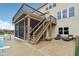 A spacious screened in porch, open deck, and lounge furniture adorn this backyard and patio at 13974 Nina Dr, Carmel, IN 46074