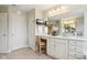 Bright bathroom with double sinks, a vanity area, and decorative accents providing ample space and a touch of elegance at 13974 Nina Dr, Carmel, IN 46074