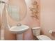 Powder room with pedestal sink, starfish decor and towel rack; great use of space at 13974 Nina Dr, Carmel, IN 46074