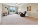 Spacious bedroom with a ceiling fan, carpet, a large window, and ample space for a study or lounge area at 13974 Nina Dr, Carmel, IN 46074