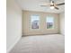 Spacious bedroom filled with natural light from two windows, with neutral carpet at 13974 Nina Dr, Carmel, IN 46074