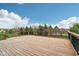 Large wooden deck with wood railing overlooking the surrounding landscaped yard at 13974 Nina Dr, Carmel, IN 46074