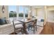 Bright dining area with deck views, charming window seat, and decorative chandelier at 13974 Nina Dr, Carmel, IN 46074