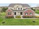 Charming two-story home featuring a combination of siding and brickwork at 13974 Nina Dr, Carmel, IN 46074