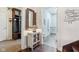 Hallway with access to laundry room with tile floors and decorative accents; stylish home at 13974 Nina Dr, Carmel, IN 46074