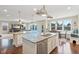 Open kitchen with granite countertops, hardwood floors, stainless steel appliances, and eating area at 13974 Nina Dr, Carmel, IN 46074