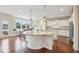 Bright kitchen featuring white cabinets, stainless appliances, hardwood floors, and a window-seat dining area at 13974 Nina Dr, Carmel, IN 46074