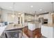 Open kitchen and dining area featuring stainless appliances, hardwood floors and granite counters at 13974 Nina Dr, Carmel, IN 46074