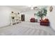 Spacious living room with two leather chairs, carpeted floor, and a ceiling fan at 13974 Nina Dr, Carmel, IN 46074