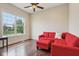Bright living room with hardwood floors, large window with neighborhood view, and red sectional sofa at 13974 Nina Dr, Carmel, IN 46074