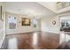 Spacious, bright formal living room featuring hardwood floors, large windows, and elegant chandeliers at 13974 Nina Dr, Carmel, IN 46074