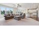 Open concept living room features large windows, ceiling fan, and easy access to dining and kitchen at 13974 Nina Dr, Carmel, IN 46074