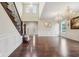 Spacious open floor plan with hardwood floors, two-story ceiling, and staircase with wooden banister at 13974 Nina Dr, Carmel, IN 46074