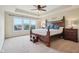 Elegantly furnished main bedroom with a decorative bed frame, ample natural light, and a serene, inviting ambiance at 13974 Nina Dr, Carmel, IN 46074