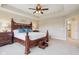 Elegantly furnished main bedroom with a decorative bed frame, ample natural light, and a serene, inviting ambiance at 13974 Nina Dr, Carmel, IN 46074