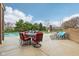 Outdoor patio with dining and lounge areas adjacent to pool, creating an ideal space for entertaining and outdoor living at 13974 Nina Dr, Carmel, IN 46074