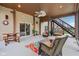 Covered patio with fan, lounge chairs, and a view of the backyard pool and landscaping at 13974 Nina Dr, Carmel, IN 46074