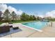 Inviting backyard pool features a clear blue swimming area, perimeter fountains, and lounge seating, perfect for summer relaxation at 13974 Nina Dr, Carmel, IN 46074