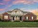 Beautiful two-story home with a brick and siding facade, front porch, manicured lawn, and professional landscaping at 13974 Nina Dr, Carmel, IN 46074