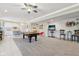 Finished basement with a pool table, tv, and kitchen in a brightly lit, spacious open floorplan at 13974 Nina Dr, Carmel, IN 46074